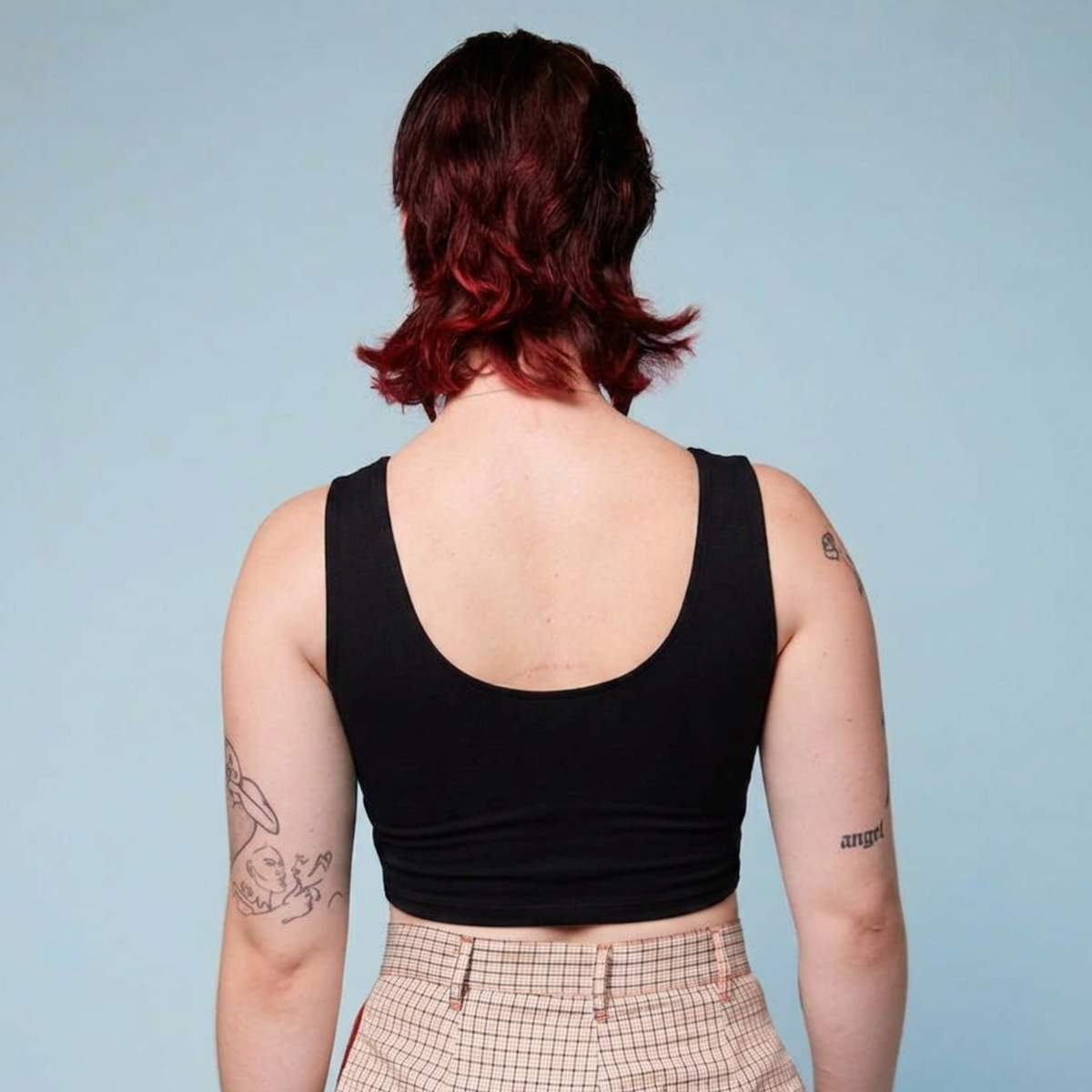 Rear view of a black, crop chest binder