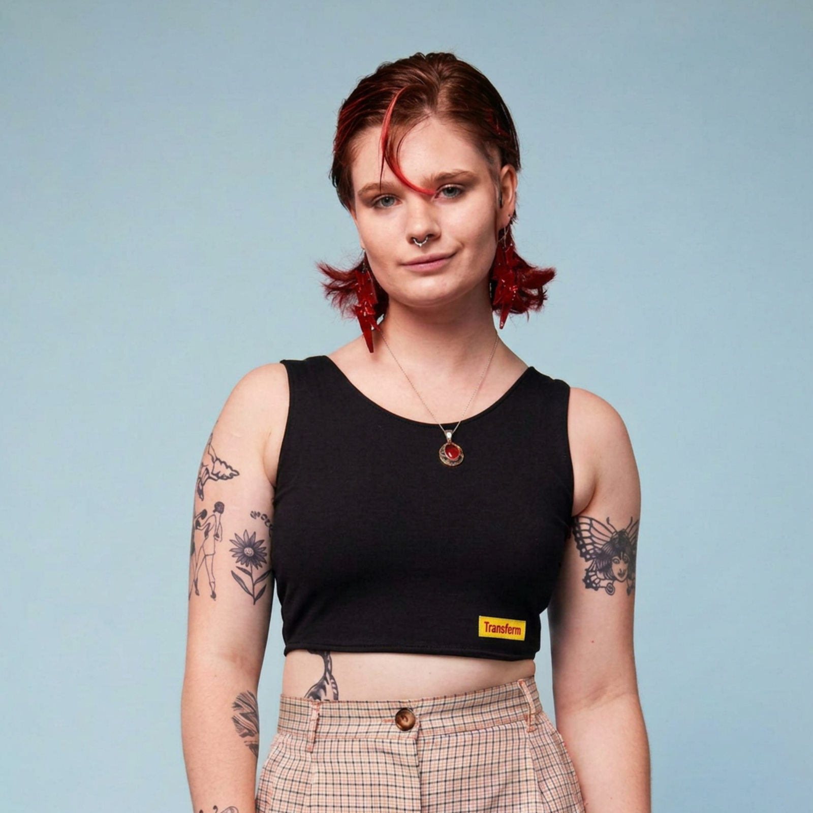 Model wearing a black, crop chest binder
