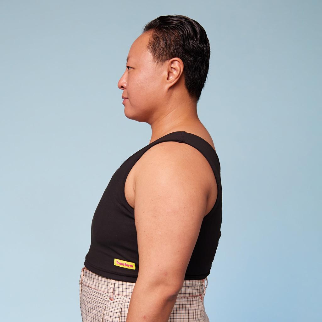 Model wearing Sensory Compression Vest Chest Binder - side view showing flattening effect