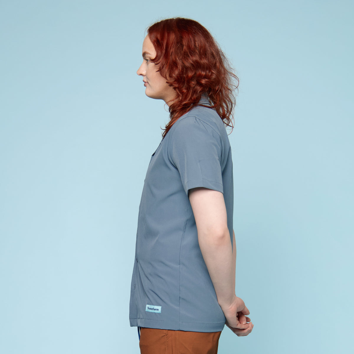 Side view of steel blue UPF 50+ swim shirt showing longer hem length and relaxed silhouette