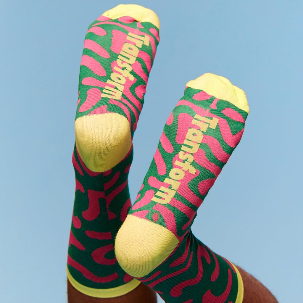 Model wearing a pair of pride socks