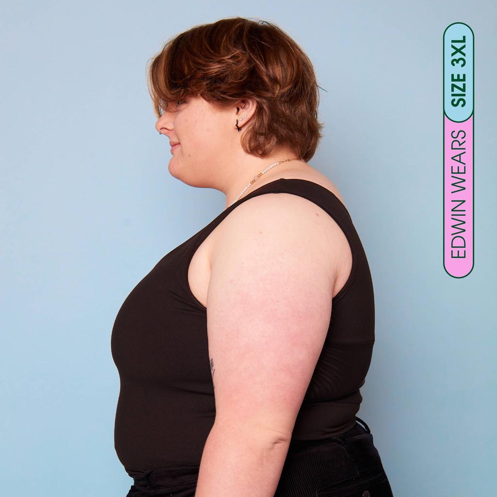 Edwin wearing plus size chest binder - side view showing flattening effect